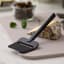 Rosti Emma Cheese Slicer - Black with a slice of cheese