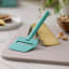 Rosti Emma Cheese Slicer - Green with a slice of cheese