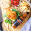 Black Mamba Foods Cayenne Chilli Sauce, 180ml with food on the table