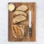 Wolstead Calibre Bread Knife, 20cm on a bread board with bread