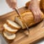 Wolstead Calibre Bread Knife, 20cm cutting a loaf of bread