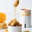 Snackadamia Gourmet Roasted Honey Flavoured Macadamia Nuts - 100g on the table