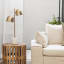 Hertex HAUS Serenity Bedside Lamp - Pure next to a couch