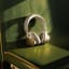 Bang & Olufsen H100 Beoplay Noise Cancelling Headphones - Hourglass Sand on a seat