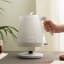 DeLonghi Ballerina Cordless Kettle, 1.7L - Marble White on the table