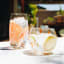 Ngwenya Glass Flecked Organic Highball Tumblers, Set of 4 - Orange on the table