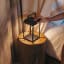 Litehouse Solar Outdoor Lantern with Touch Control - Black next to the bed
