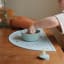 Mushie Silicone Suction Bowl, 280ml - Stone on a placemat