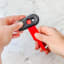 Dreamfarm Self Sharpening Cleaning Scrapers, Set of 2 handheld showing scale