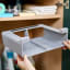 Joseph Joseph Cupboard Store Large Under-shelf Organiser placed on a shelf