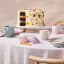 Le Creuset Jardin Relief Stoneware Mug, 350ml - Sea Salt angle on the table