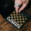 Suck UK Iron & Glory Magnetic Travel Chess Set on the table