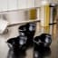 Le Creuset Gourmet Matte Black Collection Cast Iron Mini Cocottes, Set of 4 on the kitchen table