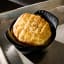 Le Creuset Gourmet Matte Black Collection Cast Iron Mini Cocottes, Set of 4 with a scone