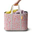 Joseph Joseph Hold-All Max Peach Collapsible Laundry Basket, 55L held on the handle