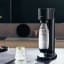 Sodastream Gaia Black Sparkling Water Maker with a glass of sparkling water