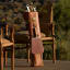 Donkey Long Tong Jack Sack Leather Carry Bag Braai Set next to an outdoor chair