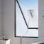 Ecovacs Winbot Mini Smart Window Cleaner on a window