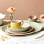 Jamie Oliver Big Love Stoneware Cosy Cuppa Mug, 375ml - Yellow on the table with a dinner set