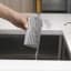 Scrub Daddy Silver Damp Duster Sponge under running water