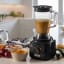 Kenwood Essentials Food Processor with Blender, 750W - Grey with food on the kitchen counter