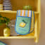 Ulster Weavers Summer Fruits Double Oven Glove on a shelf