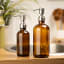&Again Amber Glass Pump Bottle - 1L in the bathroom