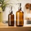 &Again Amber Glass Pump Bottle - 500ml in the bathroom