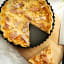 Luxe Kitchen Fluted Loose Base Quiche Pan - 23cm with a slice of pie