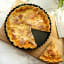 Luxe Kitchen Fluted Loose Base Quiche Pan - 25cm with a slice of pie
