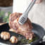 Kitchen Inspire Stainless Steel Tongs turning meat