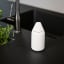 Zone Denmark Singles Soap Container - Grey next to a tap