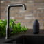 Zone Denmark Singles Soap Container - Black next to a tap