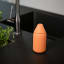 Zone Denmark Singles Soap Container - Orange next to a tap