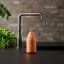 Zone Denmark Singles Soap Container - Orange next to a tap