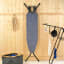 Brabantia  Denim Blue Ironing Board with Steam Iron Rest, 110cm x 30cm against a wall