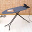 Brabantia Denim Blue Ironing Board with Solid Steam Iron Rest, 124cm x 45cm with an iron