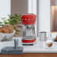 Smeg Retro Manual Espresso Coffee Machine - Fiery Red on the kitchen counter