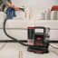 Bissell SpotClean TruHeat Cleaner on a couch
