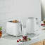 Kenwood Eterna 2-Slice Toaster, 930W - White on the kitchen counter with a kettle