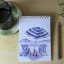 Growing Paper Beach Day Notepad with Momo Pencil on the table