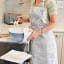 DSA Robyn Valerie Toile Du Cap Full Bib Apron - Sandy worn in the kitchen