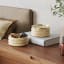 Umbra Tesora Wood Storage Box - Natural & Brass on a side table