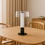 Arc & Hue Arcis Portable & Rechargeable LED Lamp - Black on a dinner table