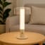 Arc & Hue Arcis Portable & Rechargeable LED Lamp - Cream on a coffee table