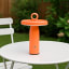 Arc & Hue Ella Portable & Rechargeable LED Outdoor Lamp - Orange on the table