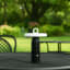 Arc & Hue Ella Portable & Rechargeable LED Outdoor Lamp - Black on the lawn table