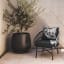 Hertex HAUS Lolita Outdoor Occasional Chair - Corfu Volcanic next to a pot plant