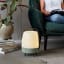 Kooduu Lite-Up Play JBL Speaker & Lamp - White/Petroleum next to a couch