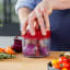 KitchenAid Hand Pull Food Chopper with red onion
